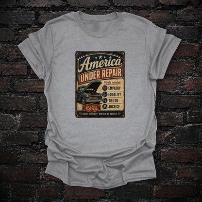 America Under Repair Political T-Shirt in Sport Grey, flat lay mockup