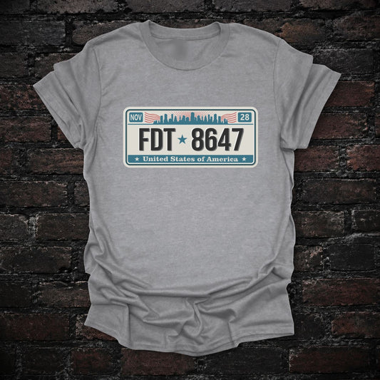 FDT 8647 Anti-Trump License Plate T-Shirt in Sport Grey, flat lay mockup