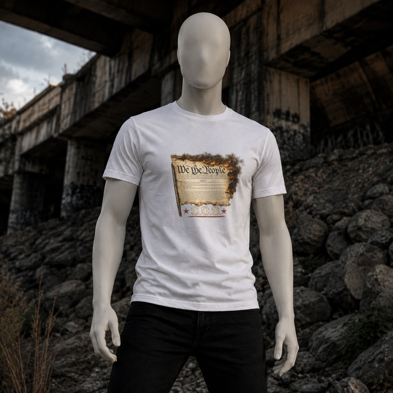 White We the People Burn T-shirt on a matte white mannequin beneath an urban overpass